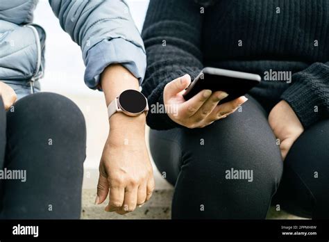 Two Beautiful Latina Women Are Proudly Displaying Their New Smartwatch And Smartphone Hispanic