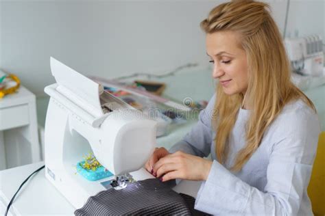 Seamstress Woman Works On Sewing Machine Dressmaker Hands Work At