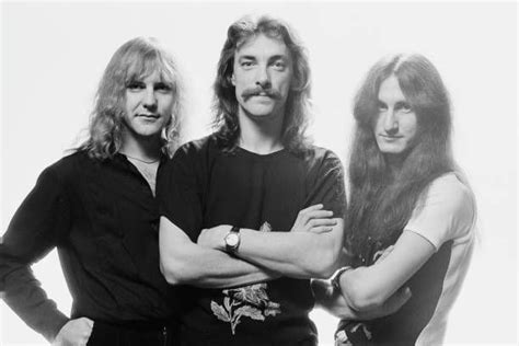 Three Men Standing Next To Each Other With Long Hair