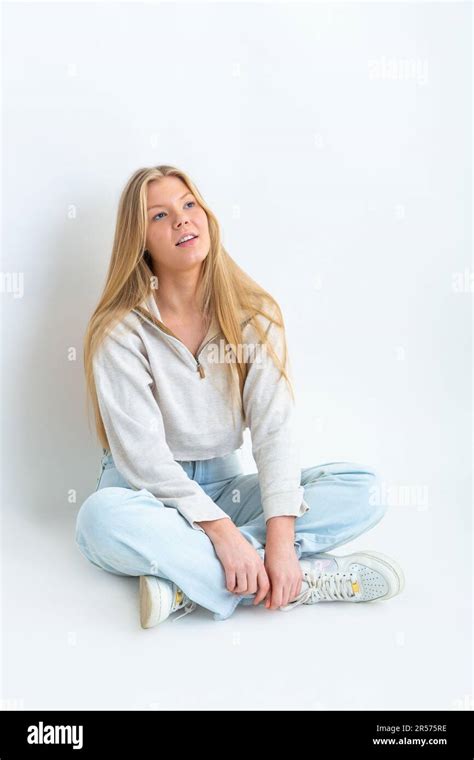 Portrait Of A Year Old Blonde Woman Sitting Crossed Legged On The Floor Stock Photo Alamy