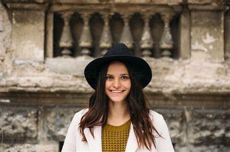 Portrait Of A Smiling Brunette With A Hat By Stocksy Contributor Marko Stocksy