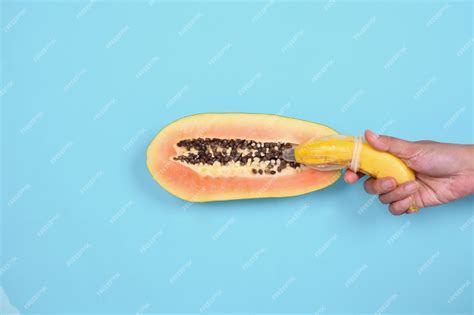 Premium Photo Abstract Sexual Health Representation With Banana And Papaya Isolated On Blue