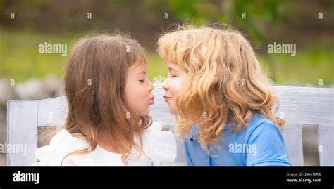 Little Boy And Girl Kissing Cheerful Kids Couple In Love Playing On