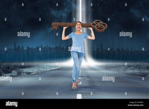Annoyed Brunette Carrying Large Key Against Road Leading Out To The Horizon With Light Beam
