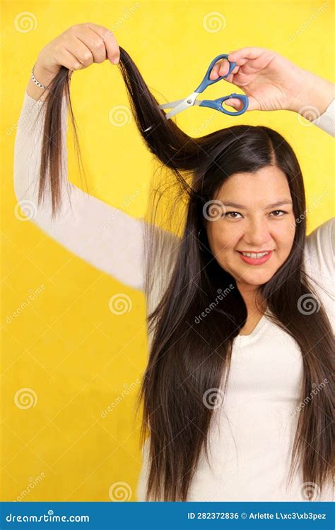 40 Year Old Latina Woman With Very Long Straight Hair Wants To Cut Her Hair With Scissors Stock