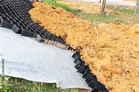 Slope erosion control grids, sheets and earth on steep slope Stock Photo | Adobe Stock