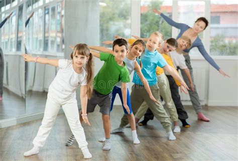 Group Of Tween Children Standing Akimbo In Row One By One Learning