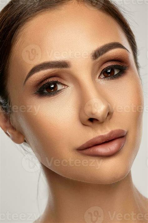 Close Up Portrait Of A Brunette Nude Model Girl With Professional Evening Make Up And Plump Lips