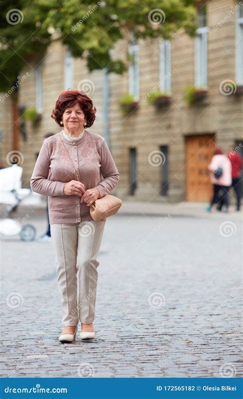 Elegant Mature Happy Woman Grandma Walking On The Street Stock Photo