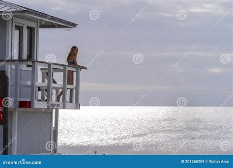 Lovely Blonde Bikini Model Posing Outdoors On A Caribbean Beach Near A Lifeguard Station Stock