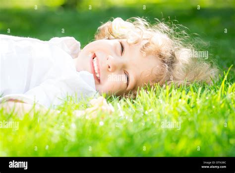 Child Lying On Grass Stock Photo Alamy
