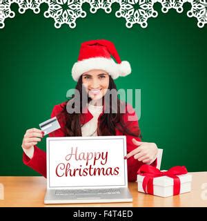 Composite Image Of Festive Brunette Shopping Online Stock Photo Alamy