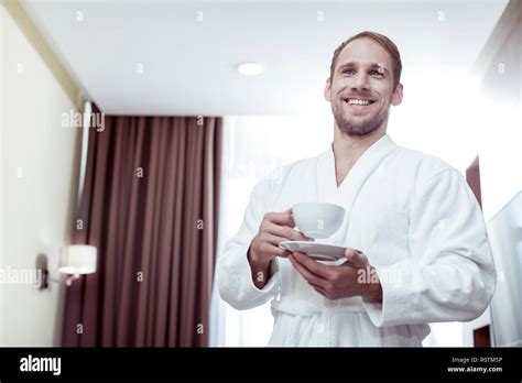 Close Up Of Beaming Blonde Haired Man Drinking His Morning Coffee Stock