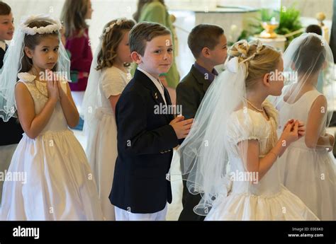 Catholic Boys And Girls Receiving The Sacrament Of First Holy Communion