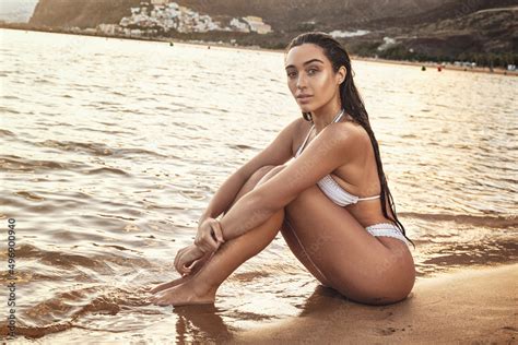 Sensual Brunette Woman In White Fashionable Bikini Posing At The Beach Sunset Time Summer