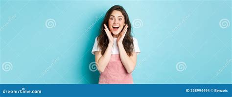 Excited Brunette Woman With Cute Curly Hairstyle Gasping Amazed And Wondered Look Surprised At