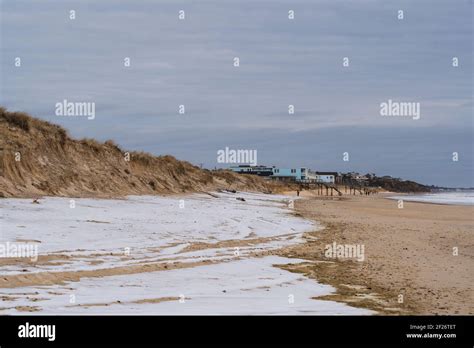 The Beach In Montauk During The Winter With Snow Covering Part Of The