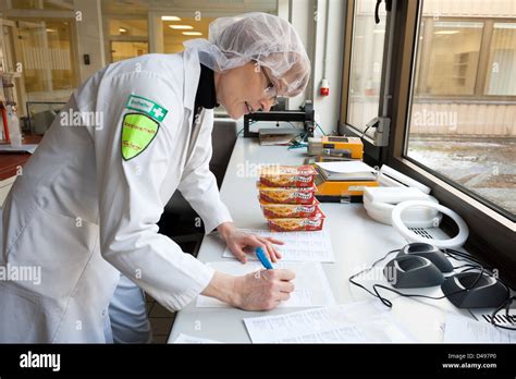Berlin, Germany, who works in the food control at Freiberger food Stock ...