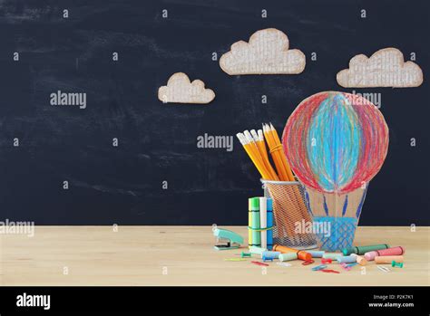Back To School Concept Hot Air Ballon And Pencils In Front Of Classroom Blackboard Stock Photo
