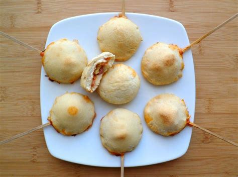 Some Food Is On A White Plate With Toothpicks