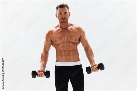 Man Athletic Body Bodybuilder Posing With Dumbbells With Naked Torso Abs Full Length In The