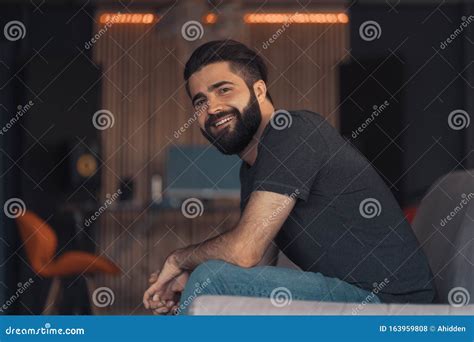 young man sitting relaxing   couch stock photo image  house