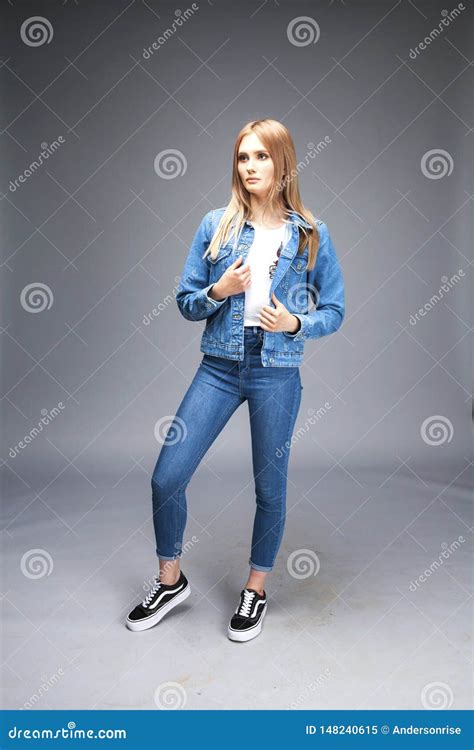 Beautiful Blonde Woman Dressed In A Denim Jacket And Blue Jeans Stock Image Image Of Beautiful