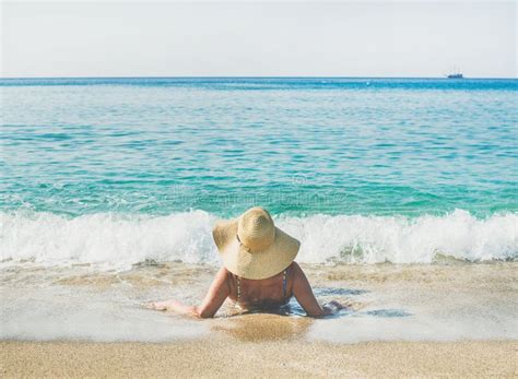 Turista Mayor De La Mujer En El Bikini Que Miente En La Arena Que Goza Del Mar Foto De Archivo
