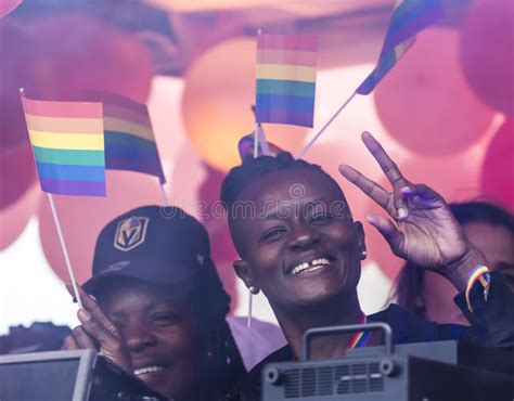 An African On A Float With A Rainbow Flag In Hair Attending The Gay Pride Parade Also