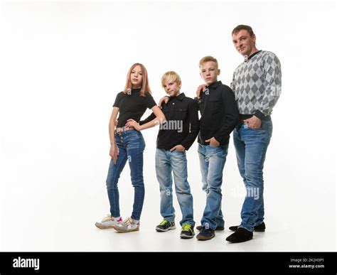 Dad Two Sons And Daughter In Casual Clothes In Dark Colors Full