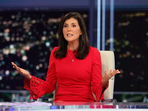 Download Caption Nikki Haley Speaking At A Conference Wallpaper