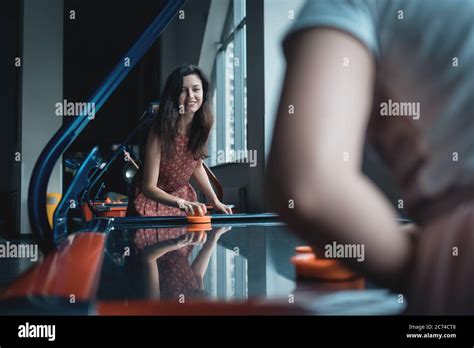 Beautiful Brunette Female Playing Air Hockey With Friend Stock Photo Alamy