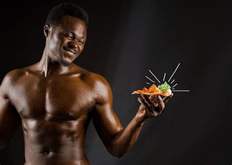 Premium Photo Black Handsome Naked Man Eats A Pizza With Cheese Boards