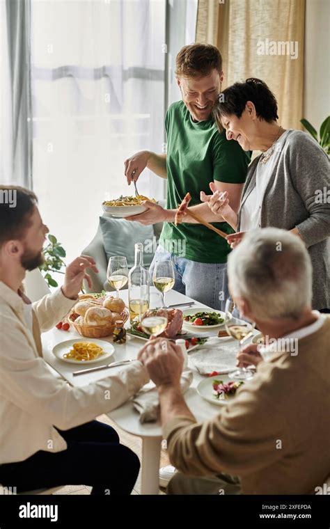 A Gay Couple Enjoys A Meal With Parents At Home Stock Photo Alamy