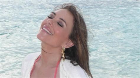 Elizabeth Hurley Flaunts Her Jaw Dropping Figure In A Skimpy Coral Bikini As She Poses For