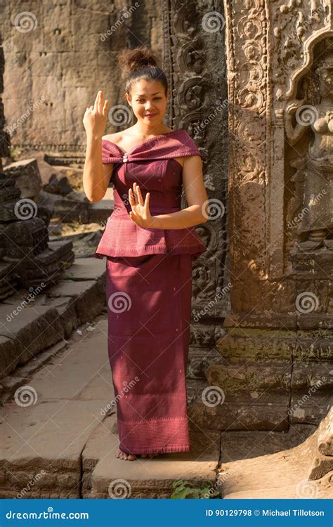 Cambodian Girl In Dancing In Khmer Dress In Ancient Building Of Angkor