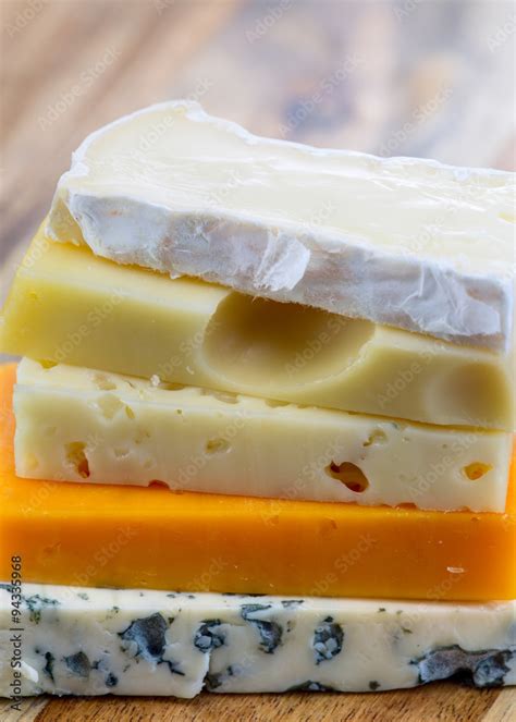 Slices of blue cheese, brie cheese, swiss cheese, red cheddar, maasdam ...