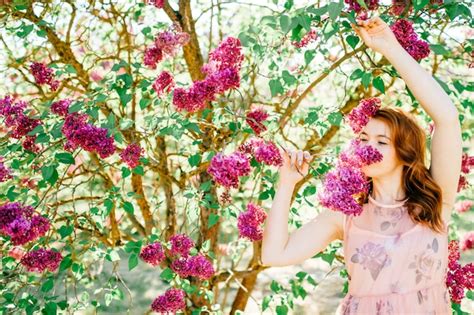 Premium Photo Beautiful Brunette Smelling Blooming Lilac