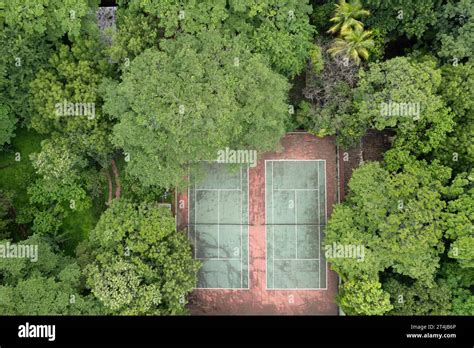 Aerial Photograph Captures Red Clay Tennis Court Nestled In The Midst