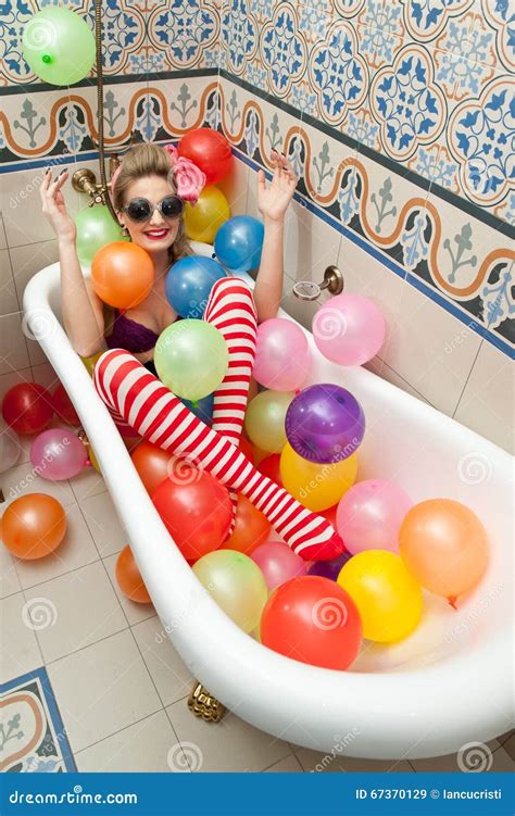 Blonde Woman With Sunglasses Playing In Her Bath Tube With Bright Colored Balloons Sensual Girl