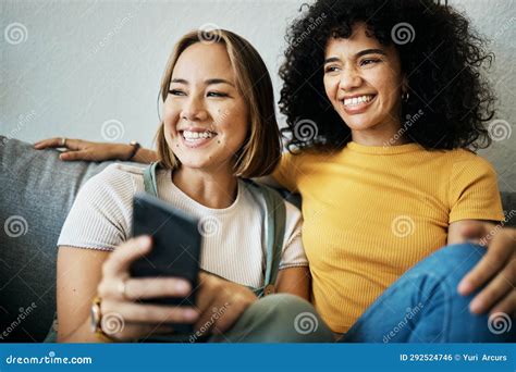 Love Smile And A Lesbian Couple Watching Tv On A Sofa In The Living Room Of Their Home Together