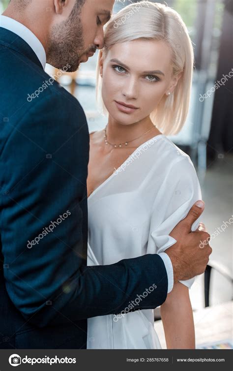 Handsome Bearded Man Hugging Attractive Blonde Woman Looking Camera Stock Photo By