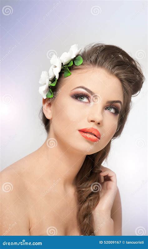 Portrait Of Beautiful Girl In Studio With White Flowers Arrangement In Her Hair And Naked