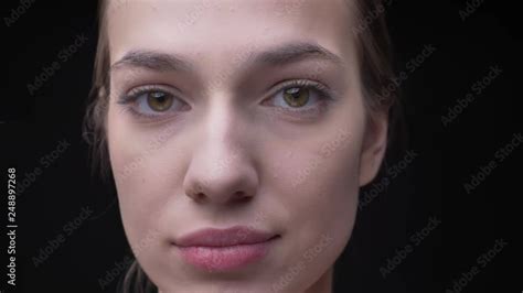 Vidéo Stock Close up portrait of young and slim caucasian girl with nude make up calmly watching