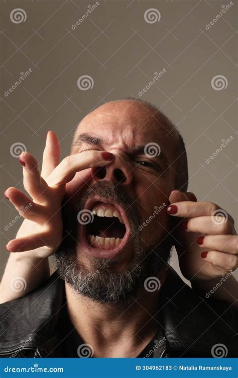 Close-up of Man with Grimace Face Expression Poses at the Studio. Mock ...