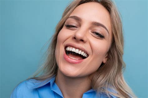 Stylish Casual Blonde Girl Flirts And Smiles On A Blue Isolated Background Stock Image Image