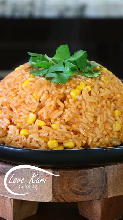 A Black Plate Topped With Rice And Corn