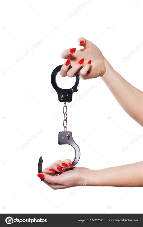 Woman Hands With Red Nails Holding Handcuffs Isolated Stock Photo