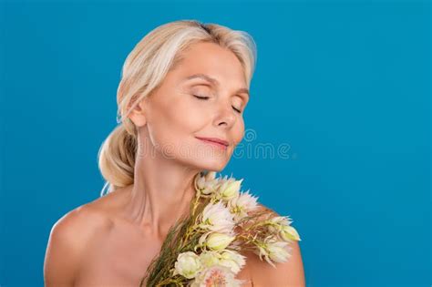 Photo Of Smiling Adorable Elderly Lady Naked Shoulders Enjoying Bunch Aroma Closed Eyes Empty