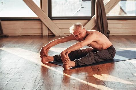 Premium Photo Senior Man With A Naked Torso Practicing Yoga Classic Asana Training In Studio